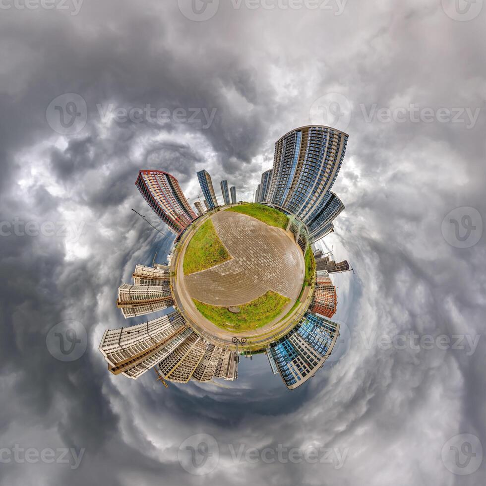 abstract swirling tiny planet spherical panorama of multi-storey buildings of skyscrapers of a residential complex in the form of a butterfly, bugs, crabs in blue sky photo