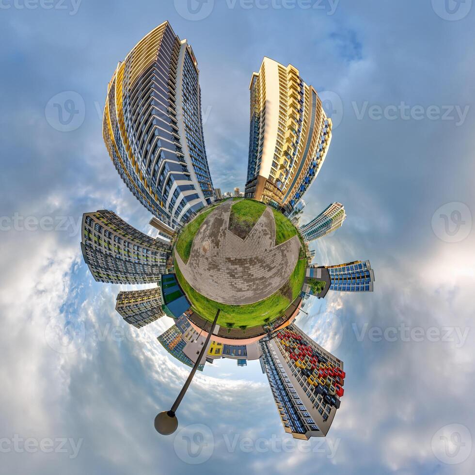 abstract swirling tiny planet spherical panorama of multi-storey buildings of skyscrapers of a residential complex in the form of a butterfly, bugs, crabs in blue sky photo