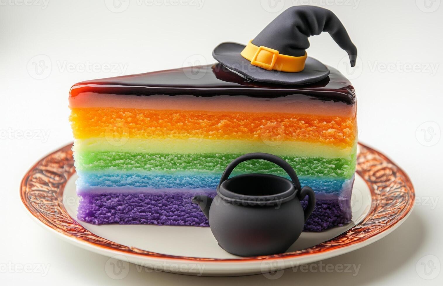 A Halloween cake slice with green, purple, orange layers, topped with a witch hat and cauldron photo
