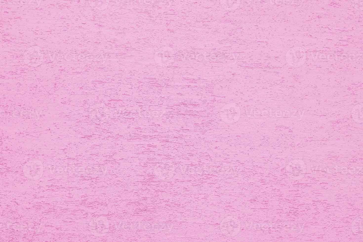 Pink plaster wall of a building. Rough surface texture. photo