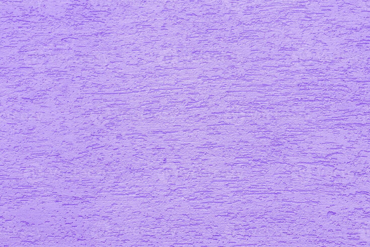 Violet plaster wall of a building. Rough surface texture. photo