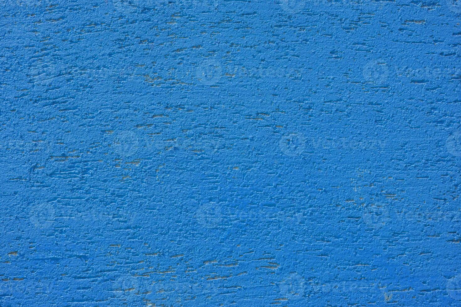 Blue plaster wall of a building. Rough surface texture. photo