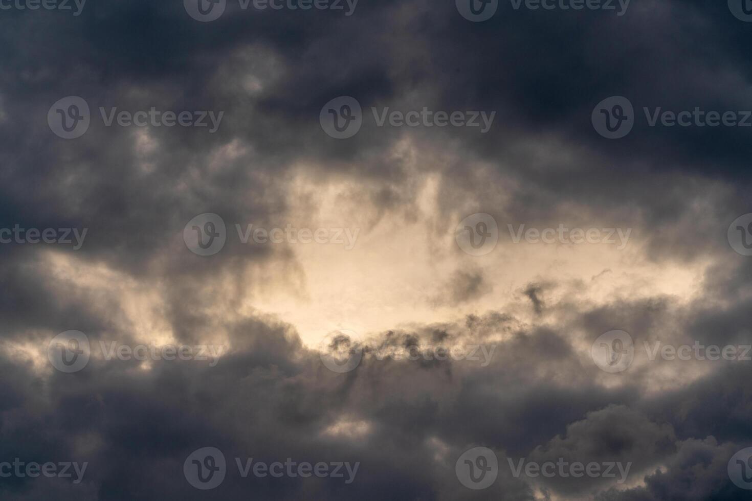 Dark gloomy clouds on a stormy sky. Natural atmospheric background. photo