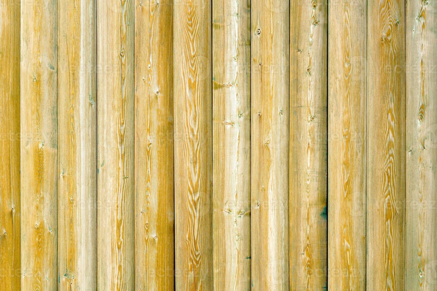 Vintage fence of old wooden boards. Texture of an aging wooden surface. Beautiful wooden background. photo