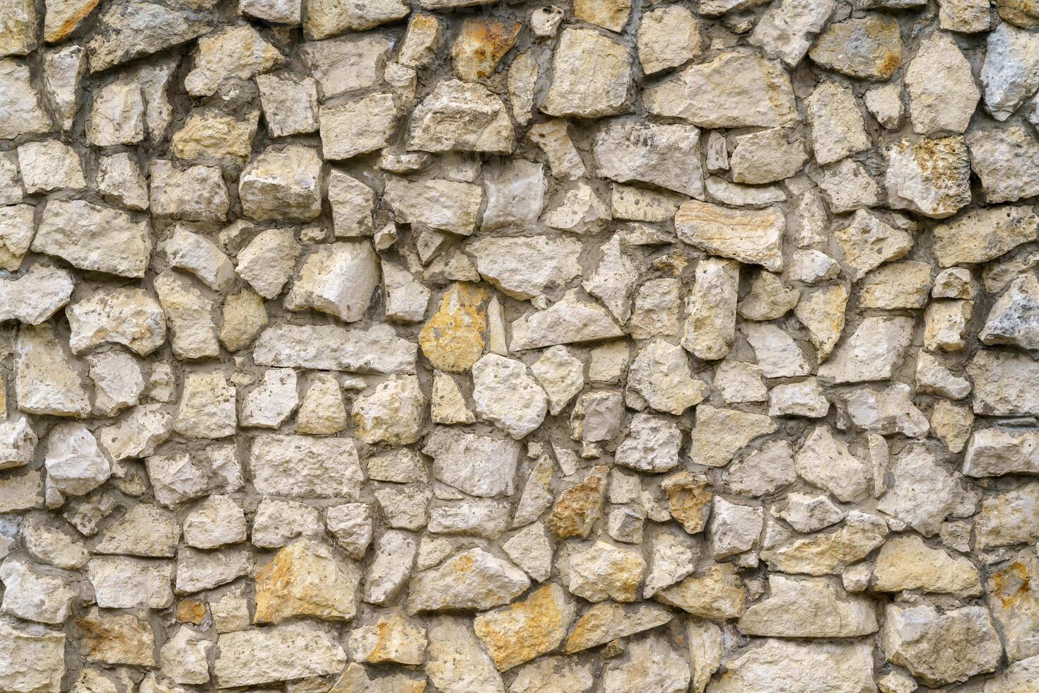 Wall of gray stones. Stone building background. photo