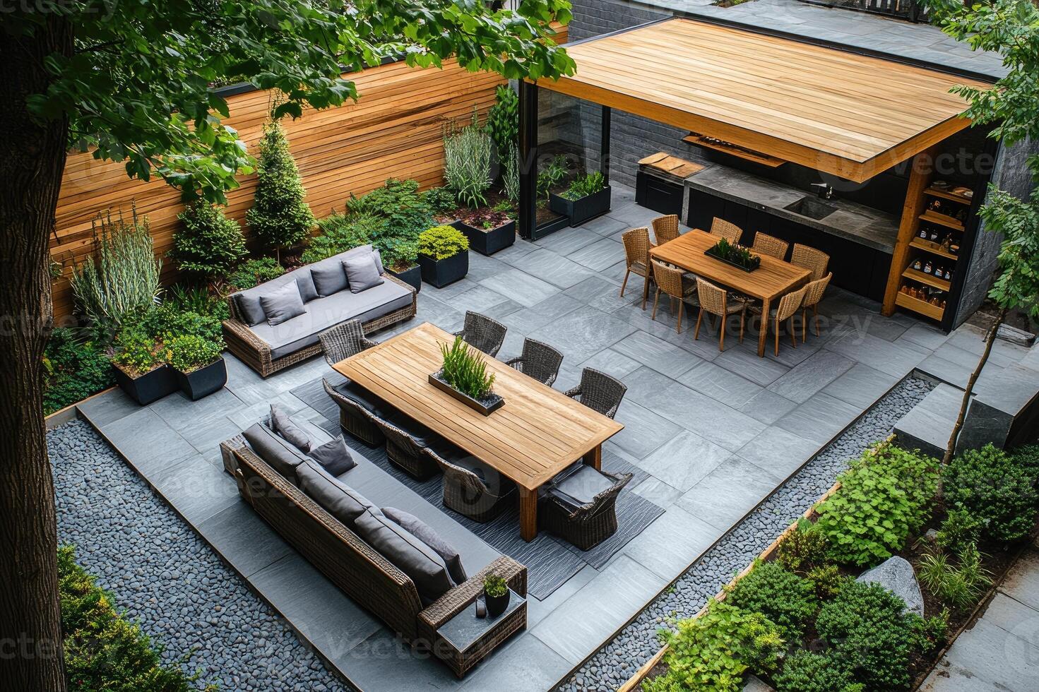 Modern backyard patio design featuring outdoor kitchen and dining area photo