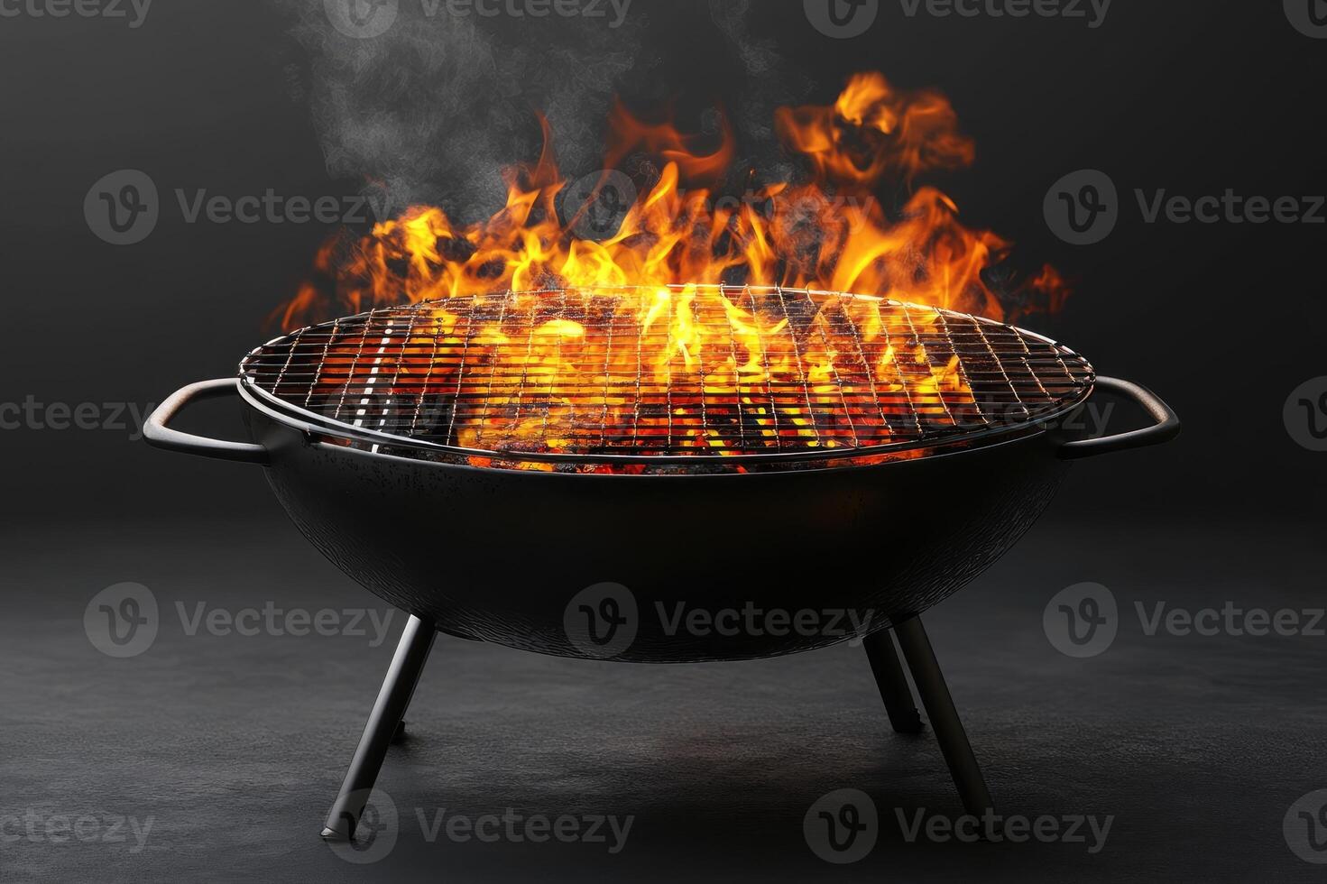 Empty barbecue burning with bright orange flames on dark background photo