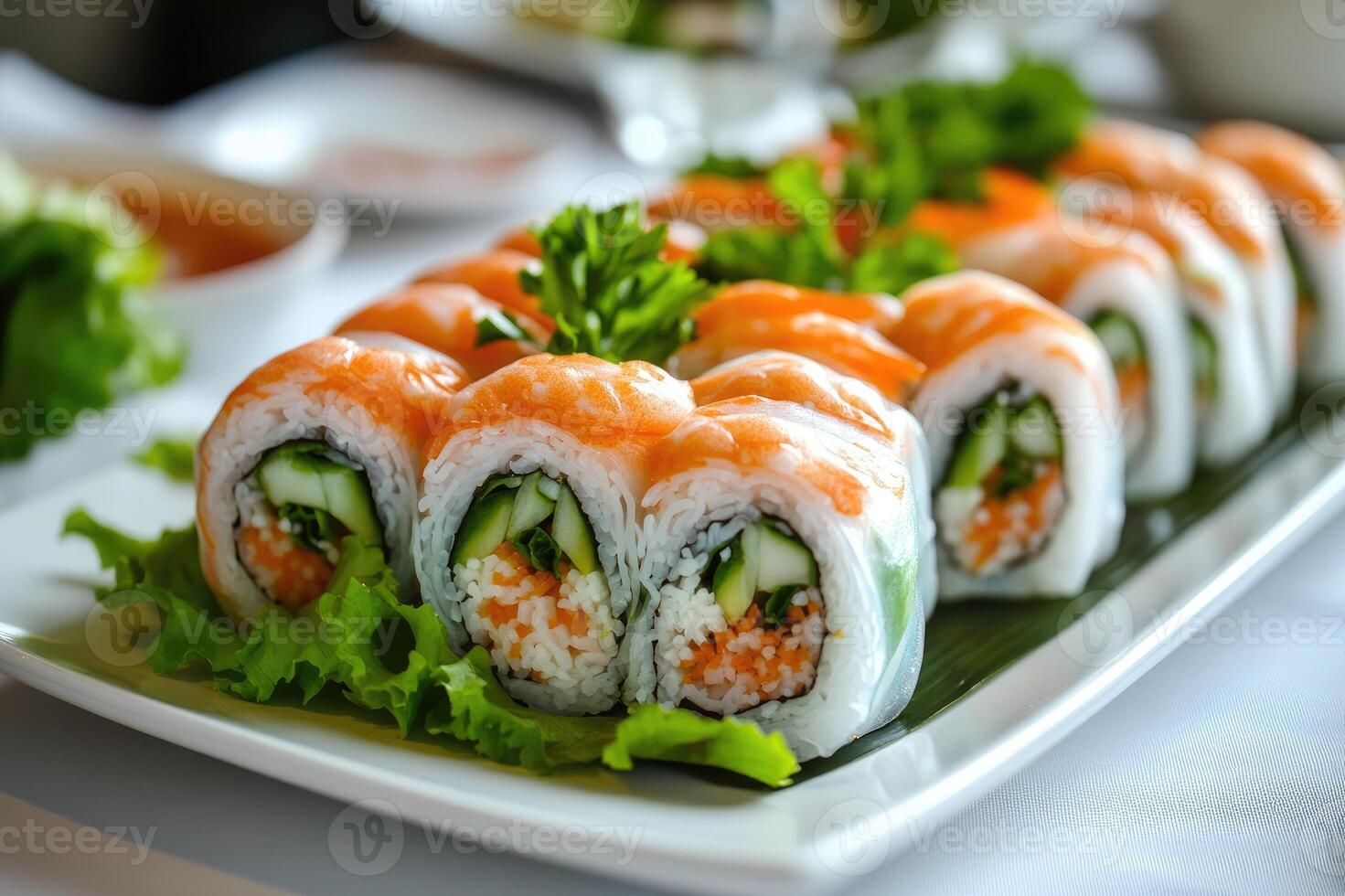 Vietnamese spring rolls decorated with flower carving being served on banana leaf photo