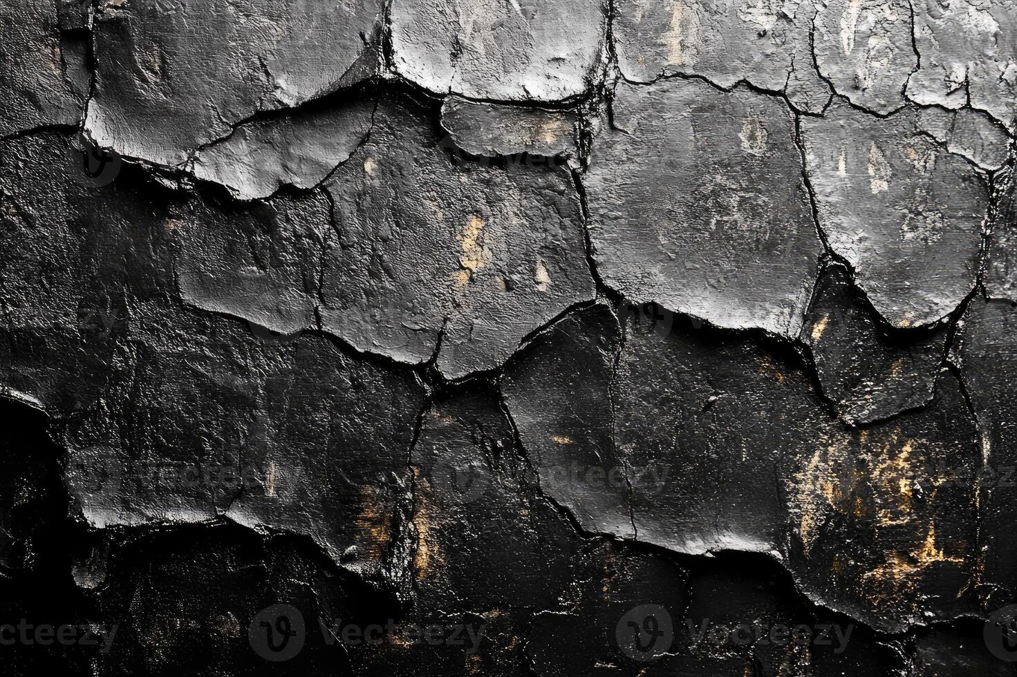 Black and gold abstract wall texture showing cracked paint photo