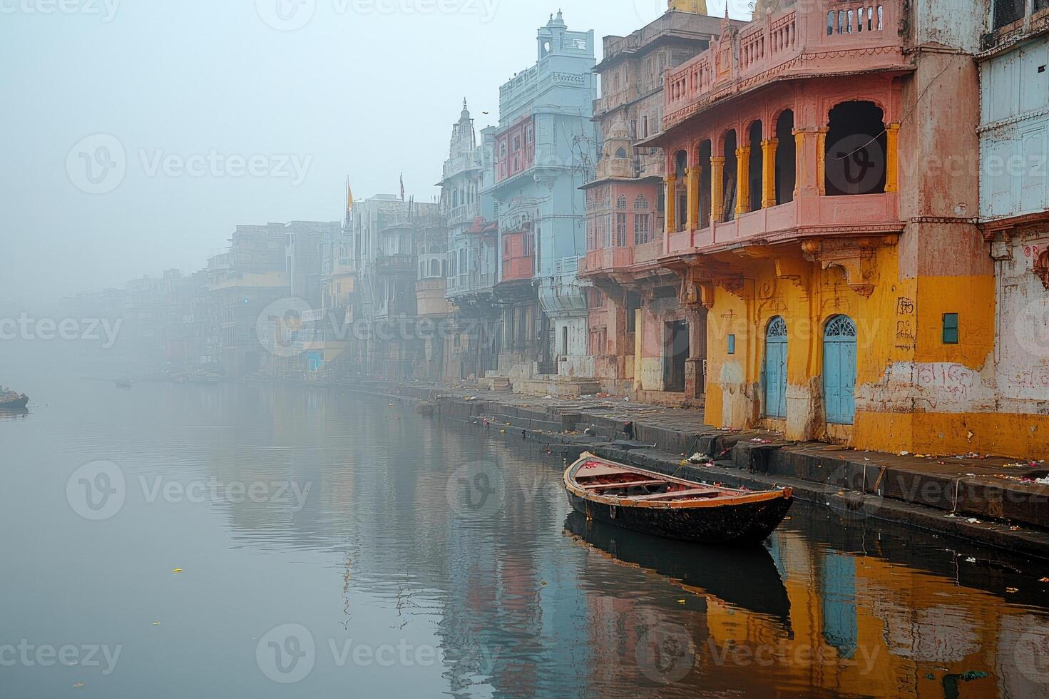 Ancient indian architecture reflecting on ganges river at sunrise in varanasi photo