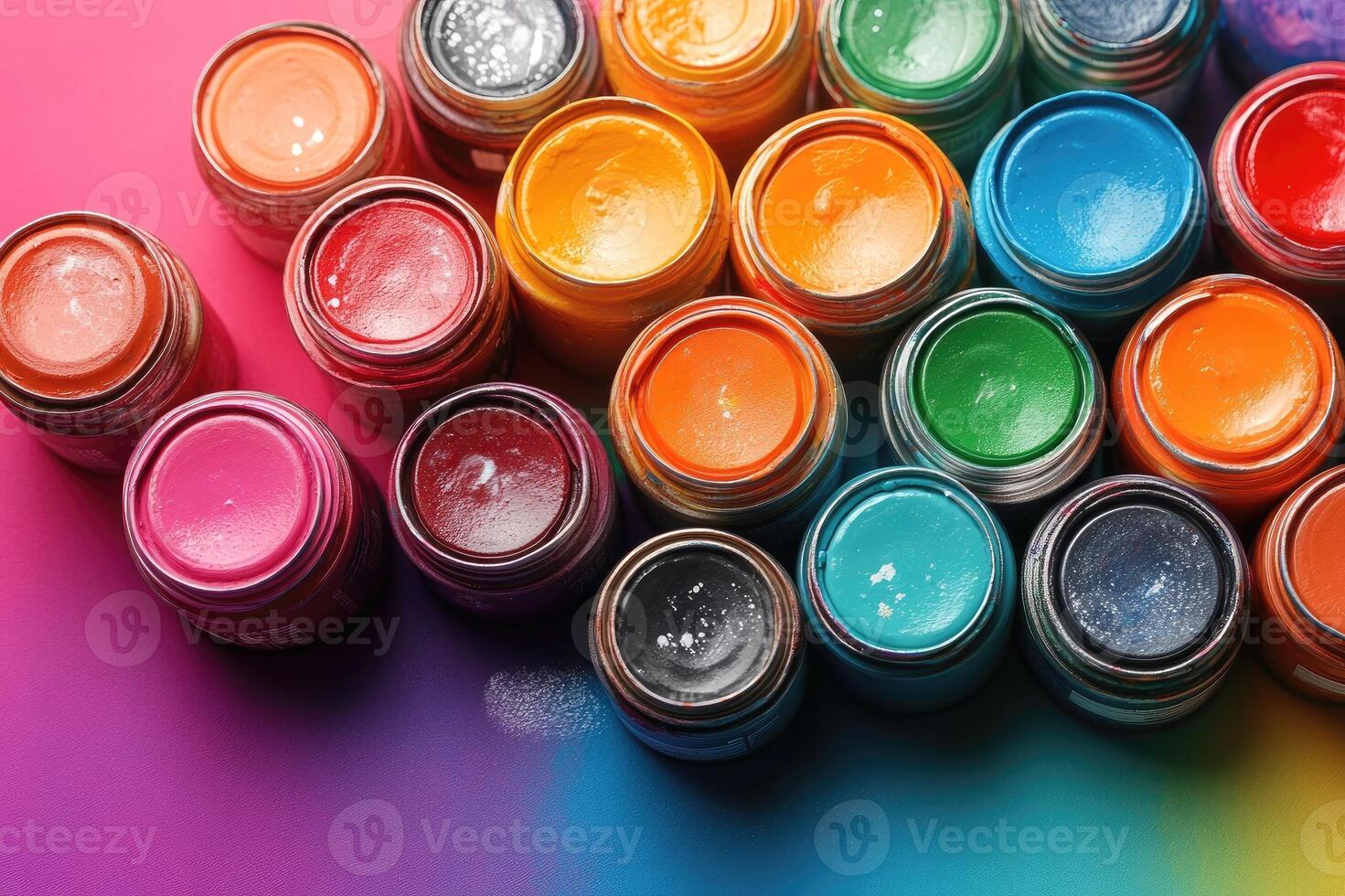 Colorful paint cans arranged on artist's workbench forming a creative background for design photo