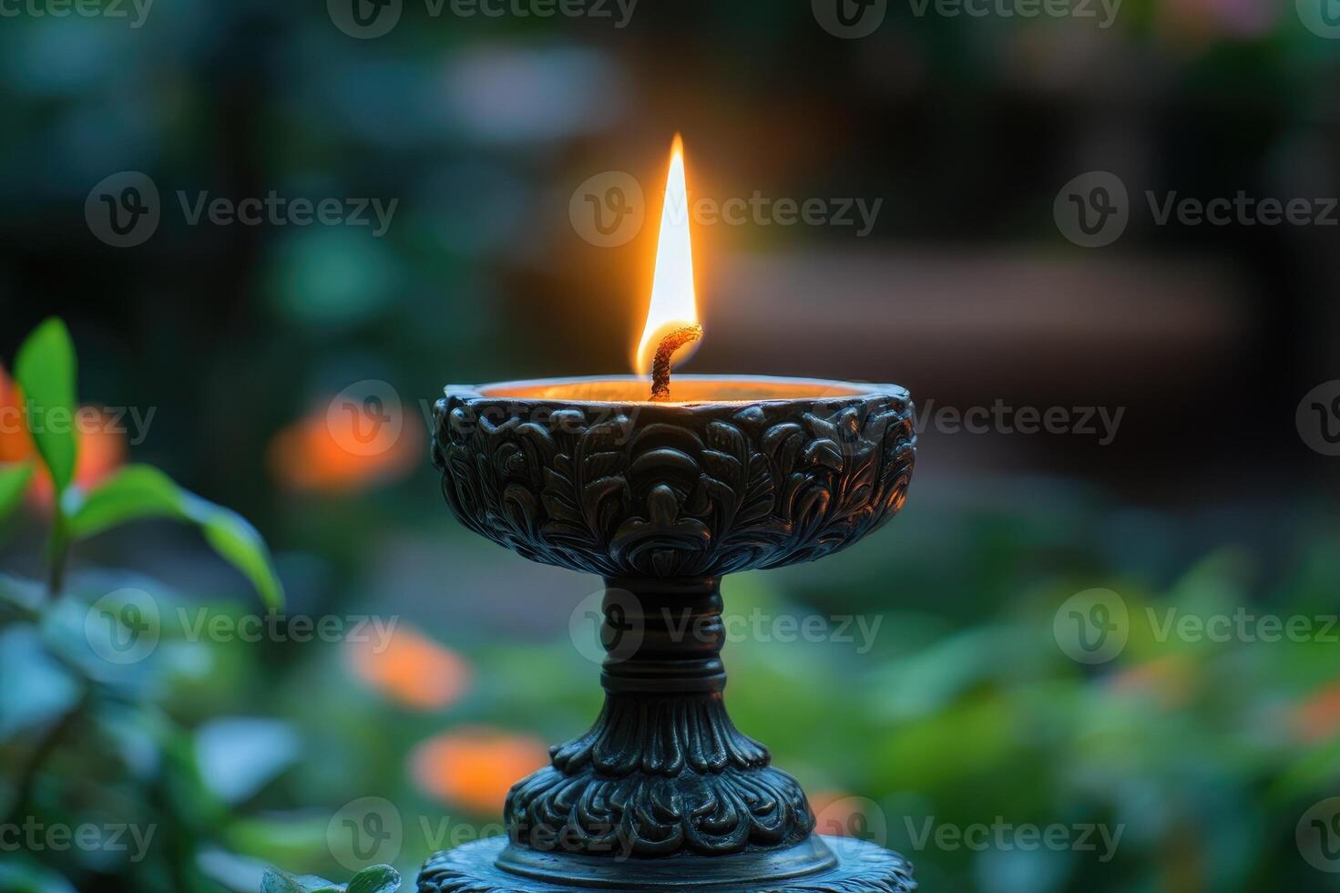 Burning oil lamp standing on a floral background photo