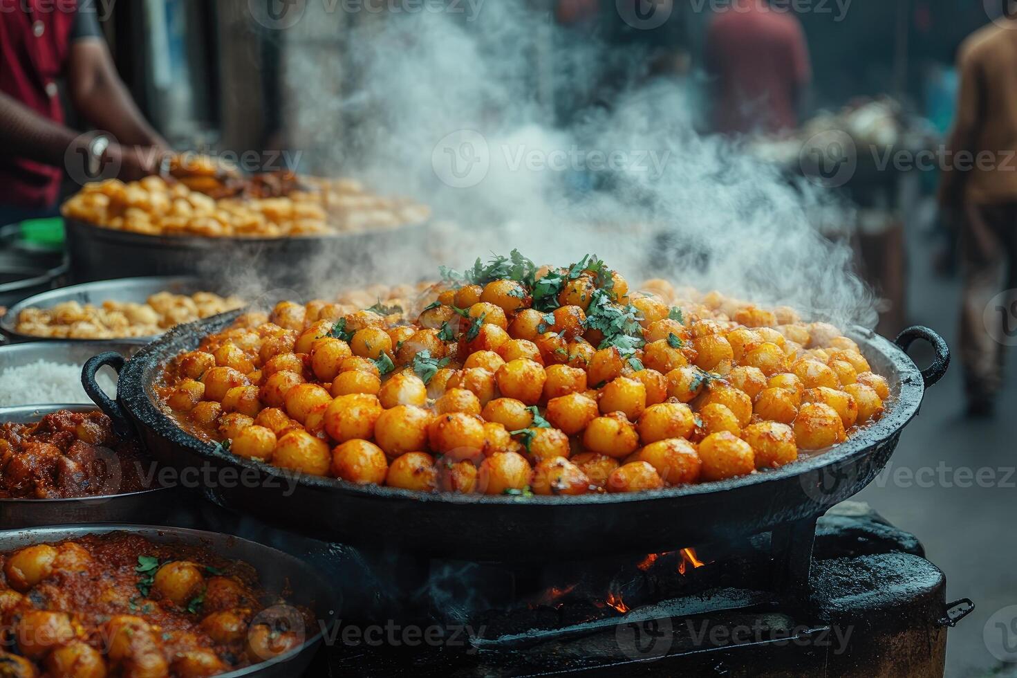 Street food vendor preparing steaming hot spicy potatoes in wok photo