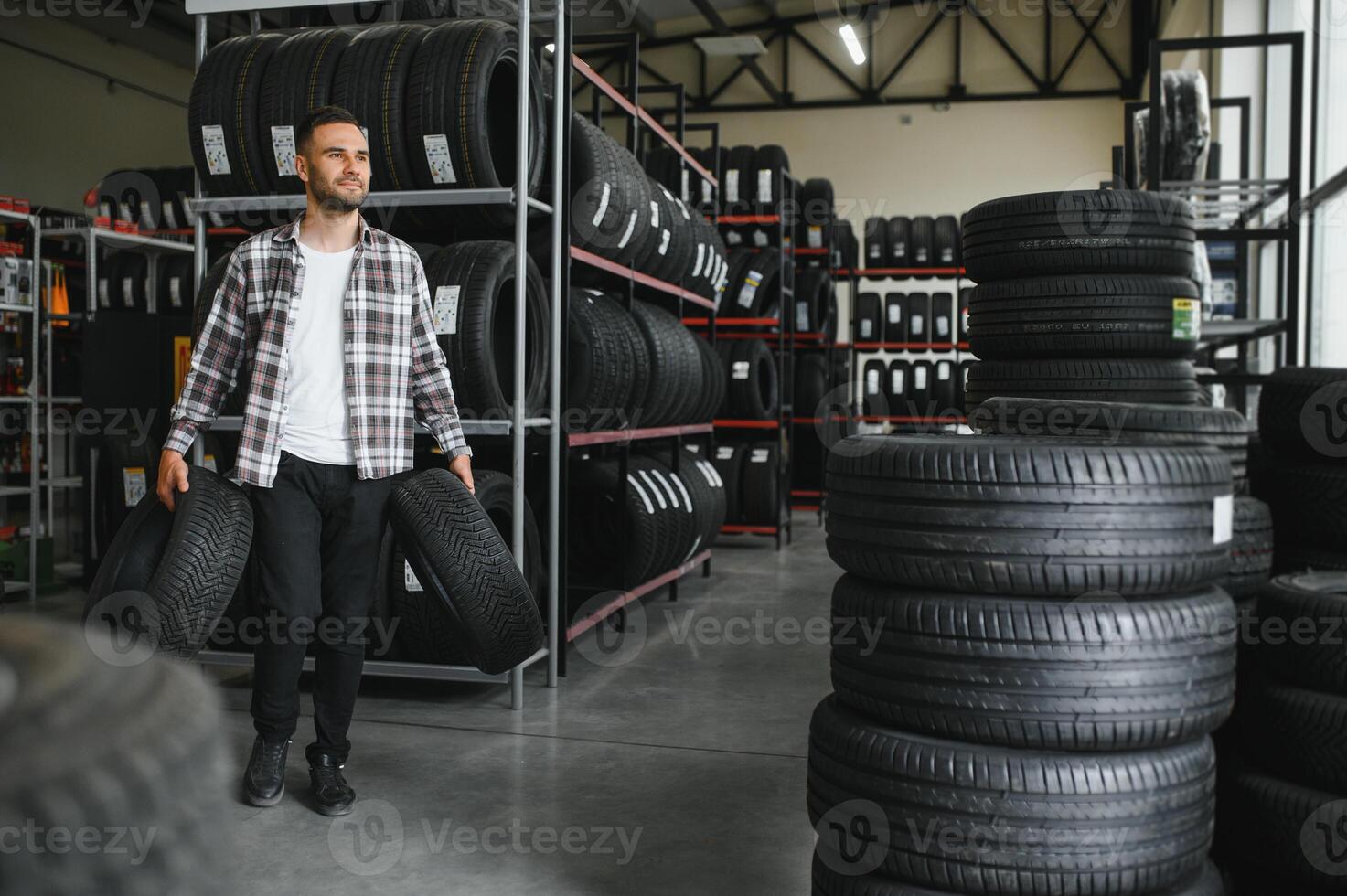 A male customer in a car tire shop photo