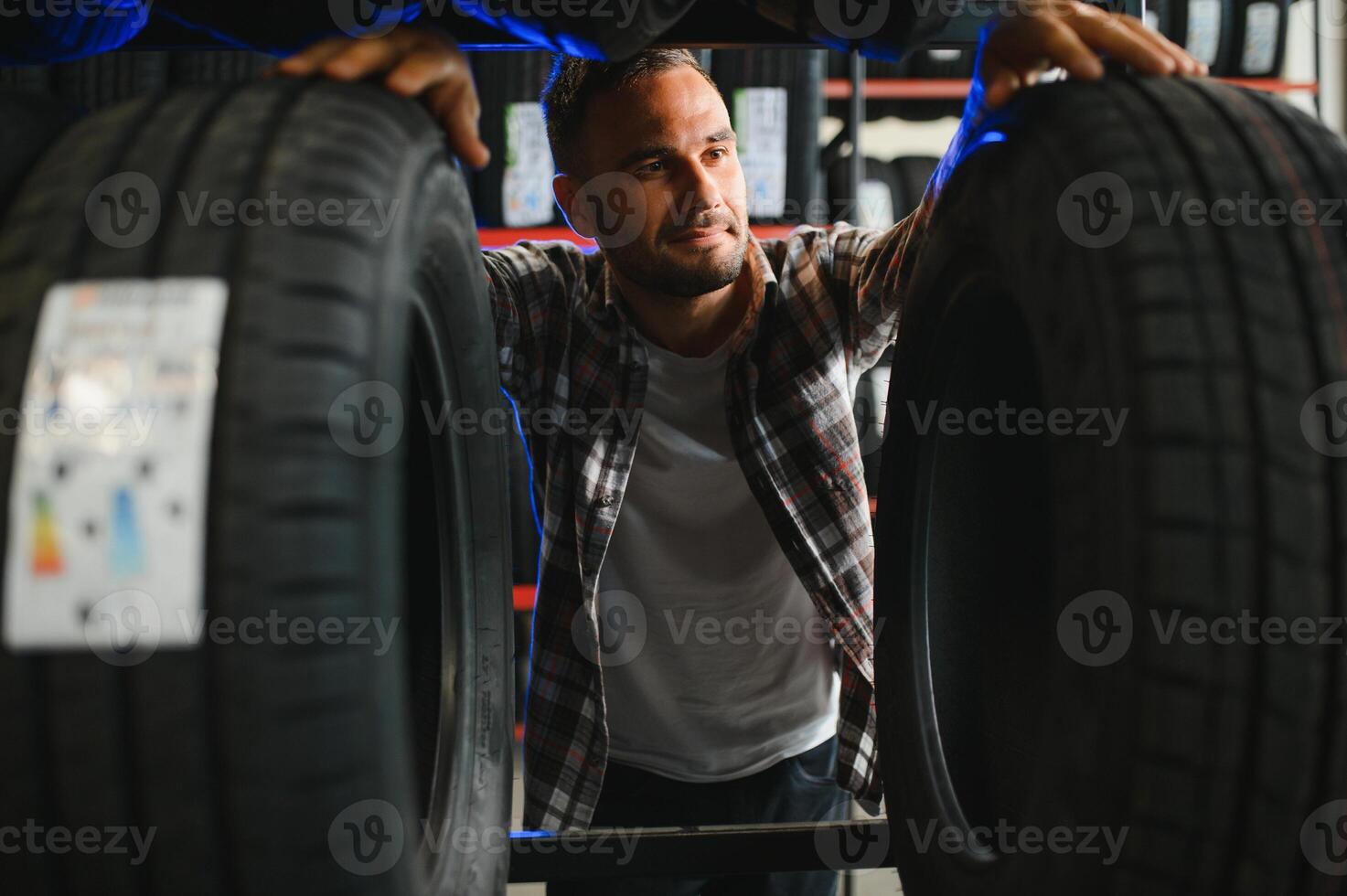Man chooses winter car tires in the auto shop photo