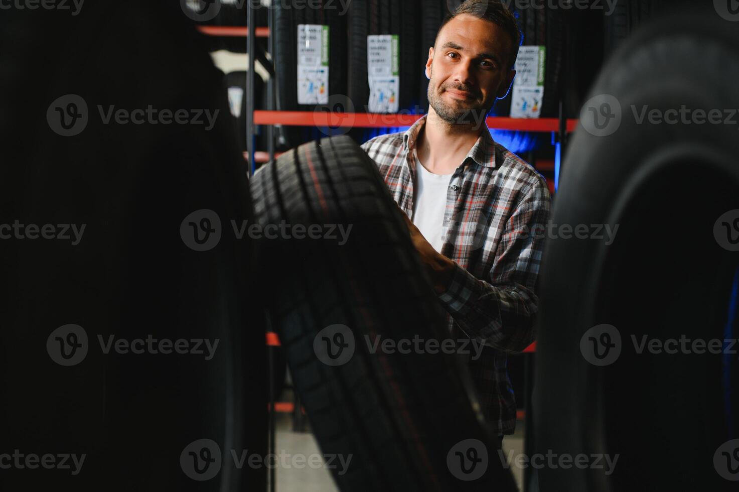 Man chooses winter car tires in the auto shop photo