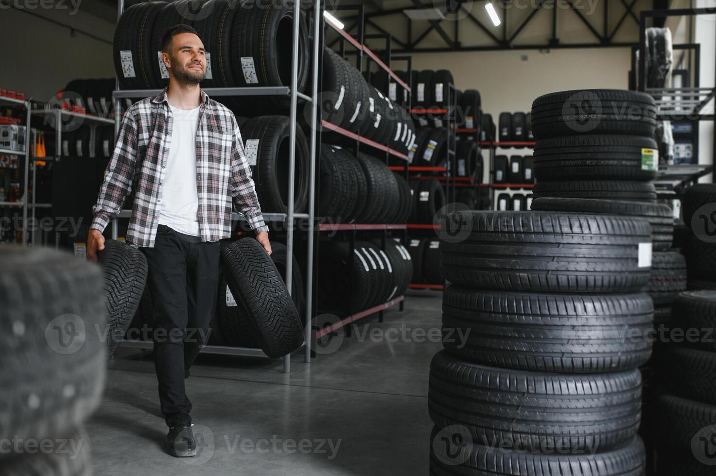 A male customer in a car tire shop photo