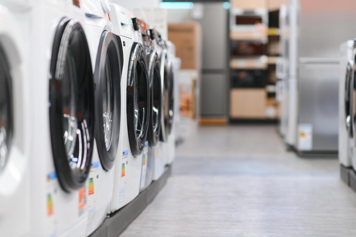 Rows of modern washing machines in a store photo