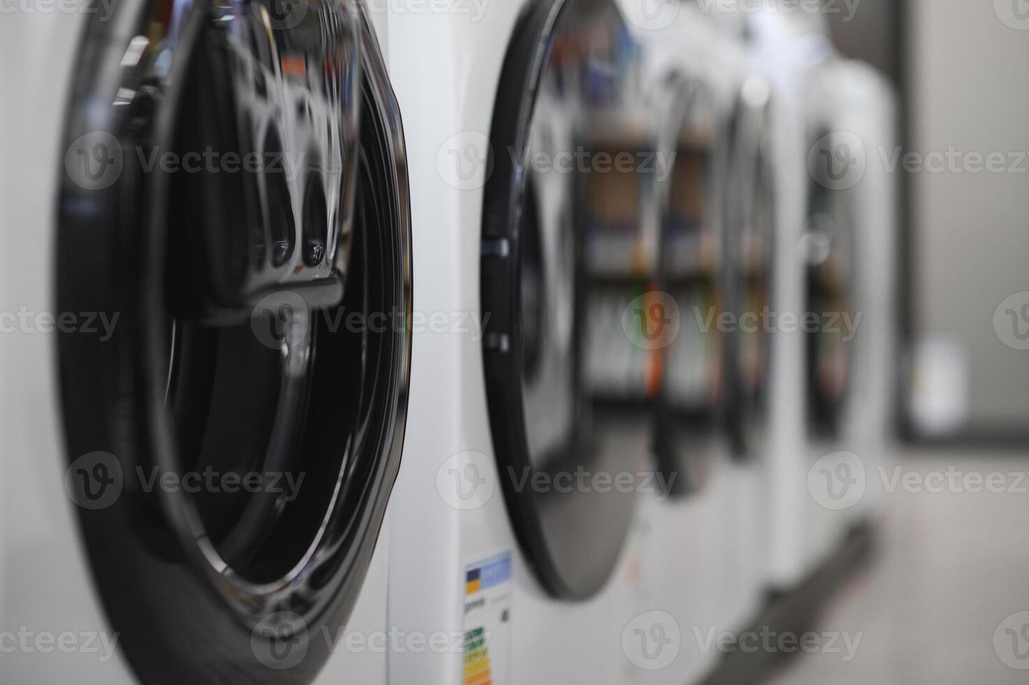 Rows of modern washing machines in a store photo