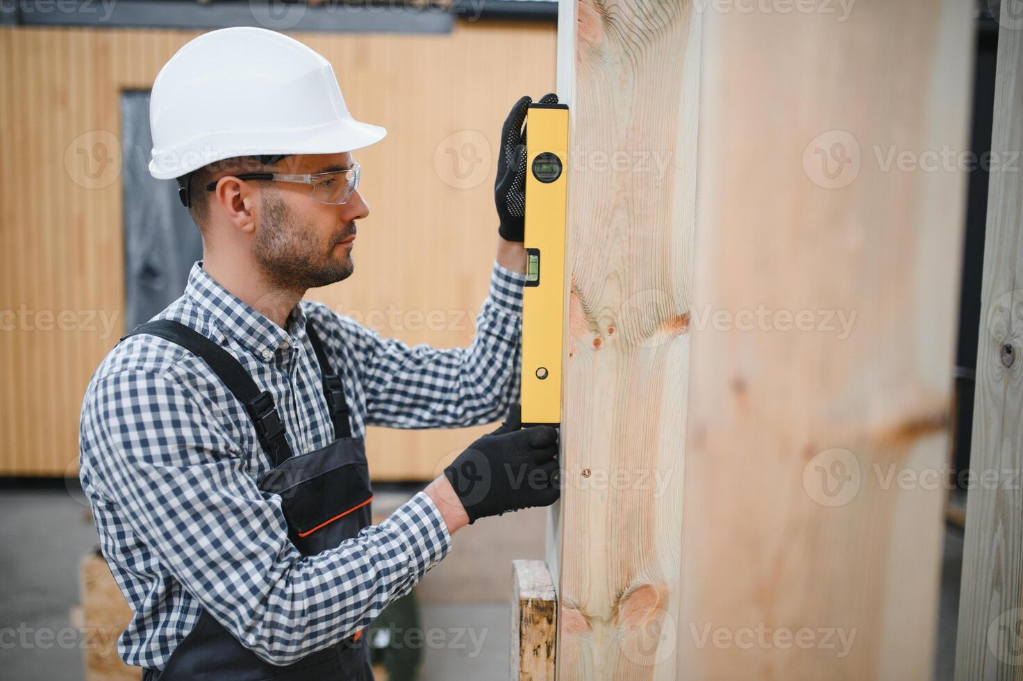 Process of construction new and modern modular house. Worker man in special protective uniform wear working on building development industry of energy efficient property photo