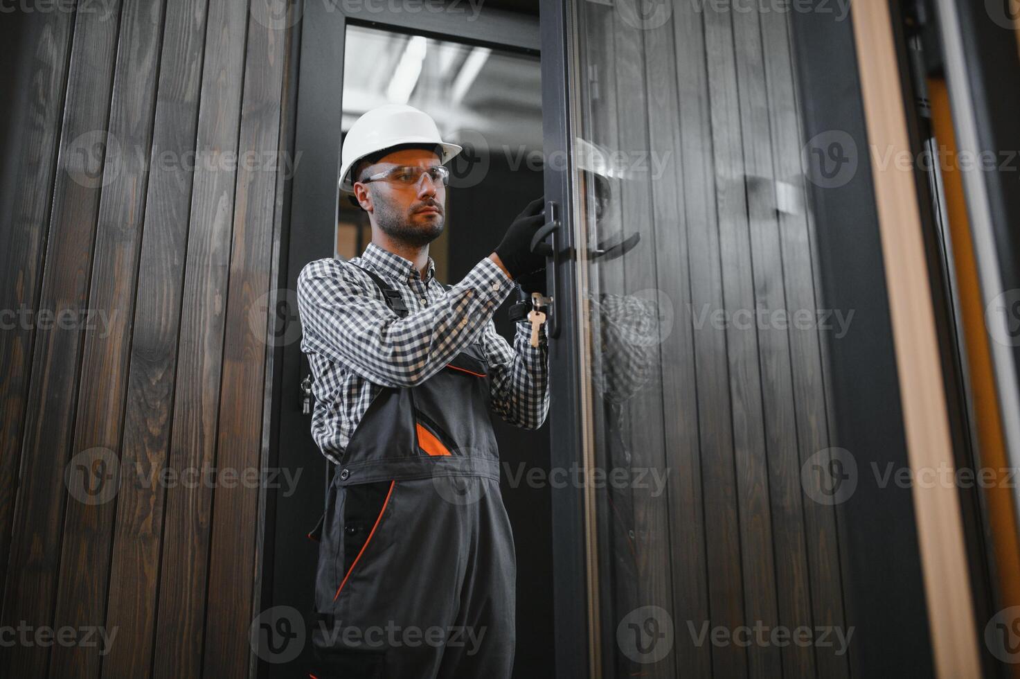 Process of construction new and modern modular house. Worker man in special protective uniform wear working on building development industry of energy efficient property photo