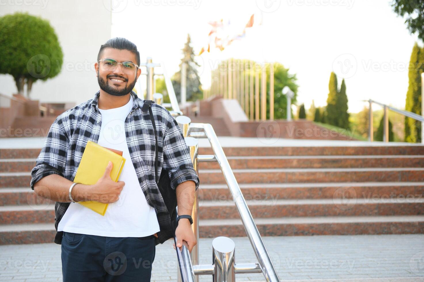 Happy indian male student at the university photo