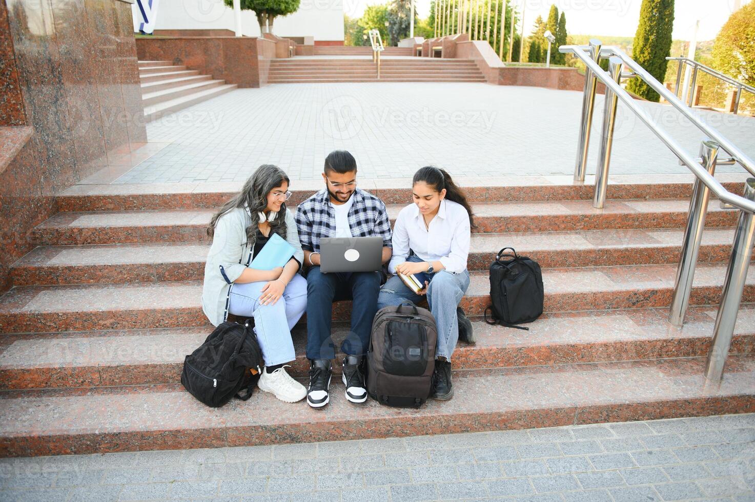 Group of smiling multiethnic near university campus photo