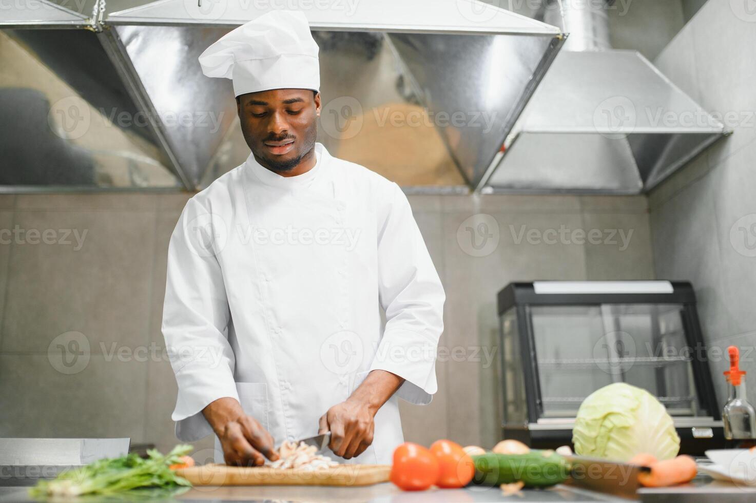 handsome african american chef at restaurant kitchen photo