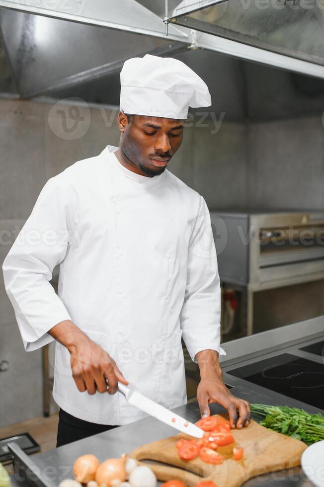 handsome african american chef at restaurant kitchen photo