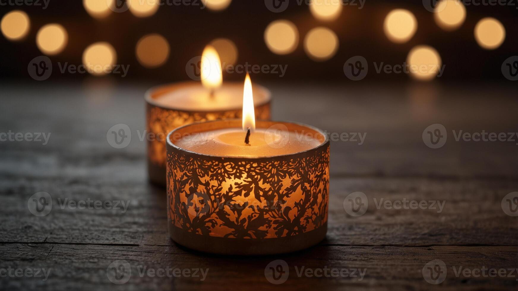 Candles and decorative items on wooden table with warm lighting. photo