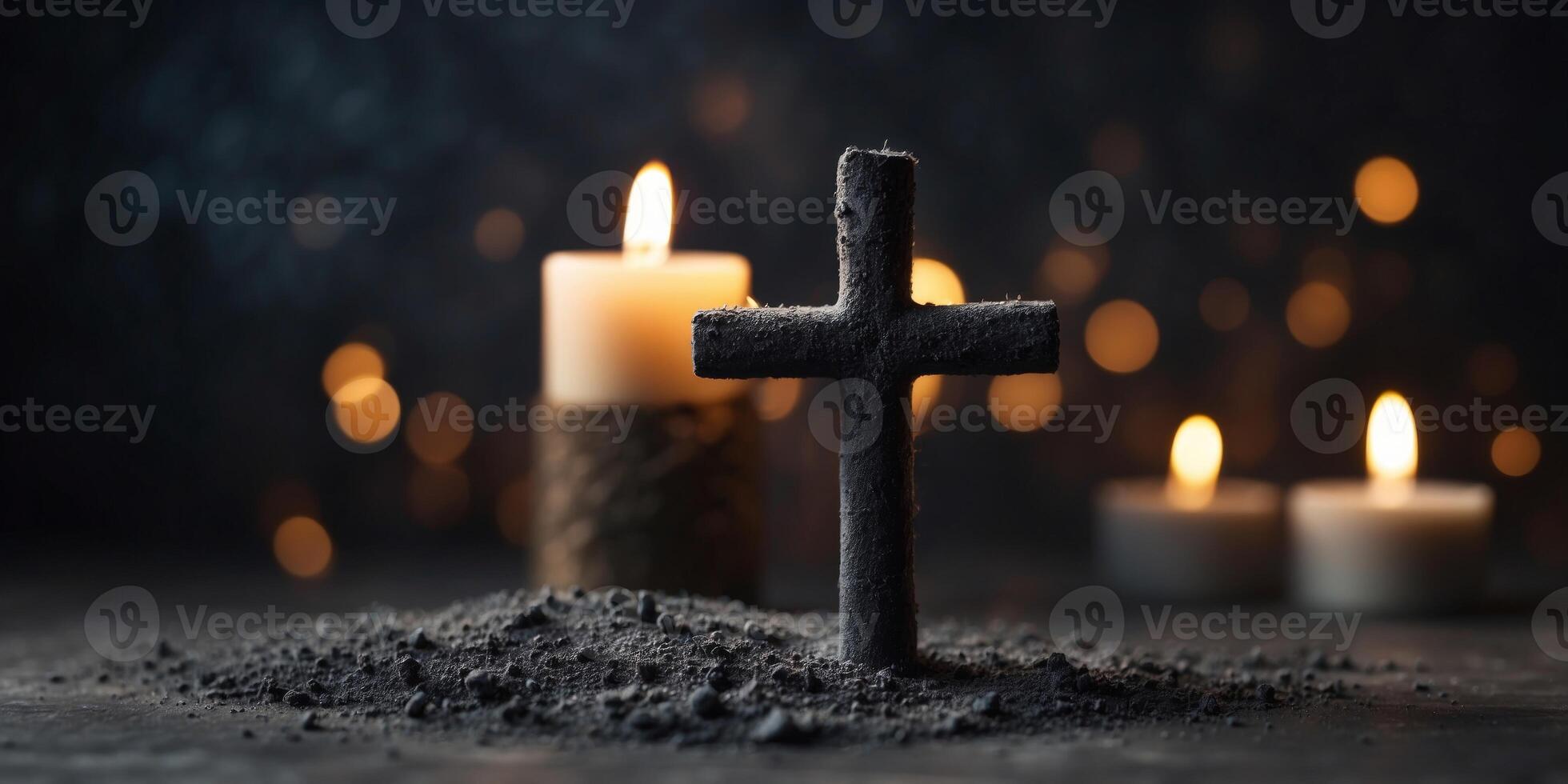 Christian cross made of charcoal dust with candlelight. photo