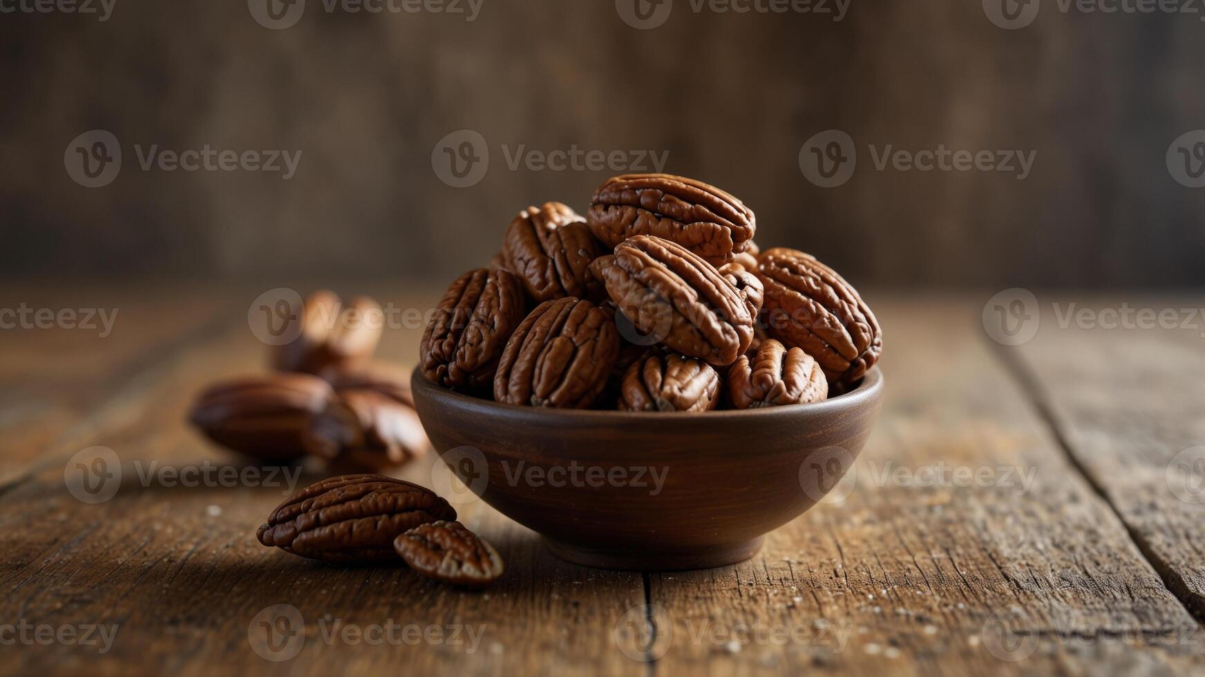 Bowl of unshelled pecans on a rustic wooden table. photo