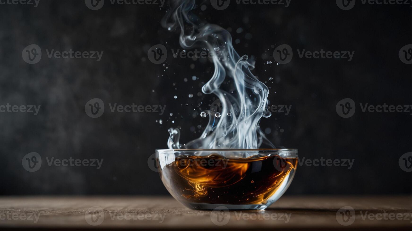 Dramatic splash of liquid in glass bowl with smoke effect. photo