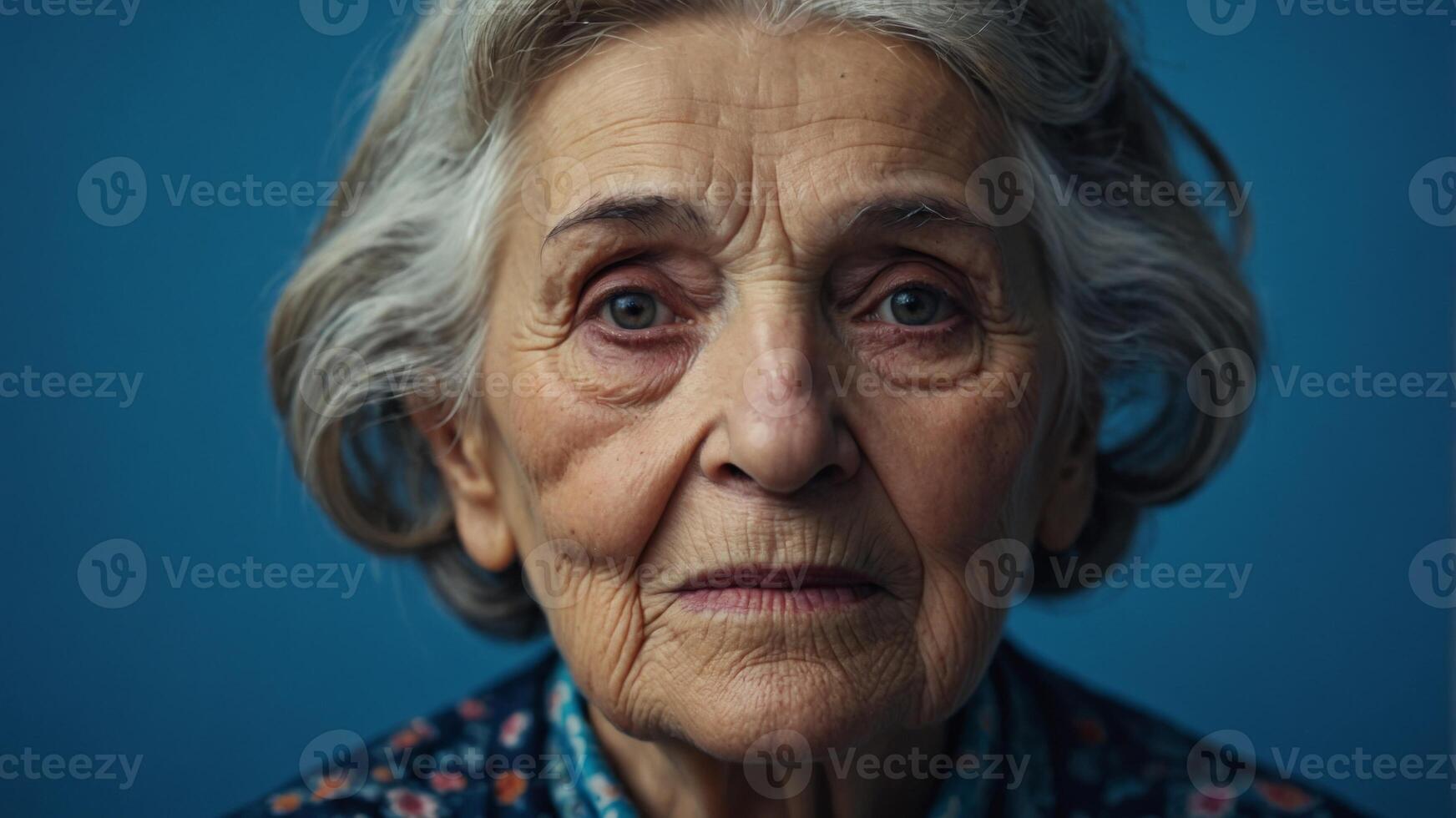 Old woman grandmother face on blue background, close up view. photo