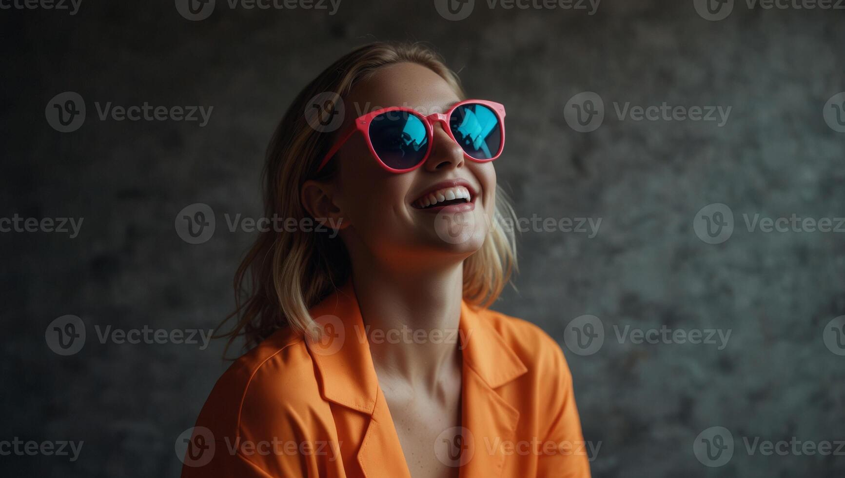 Joyful woman wearing a vibrant neon ensemble, playful sunglasses, and a flamboyant fashion sense, exuberantly laughing and beaming, striking trendy poses in a studio. photo
