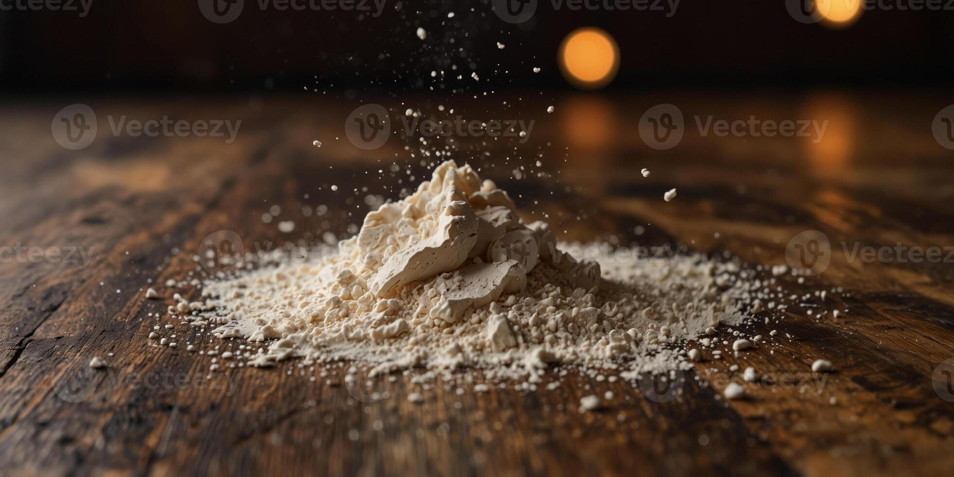 Flour scattered on a wooden kitchen table. photo
