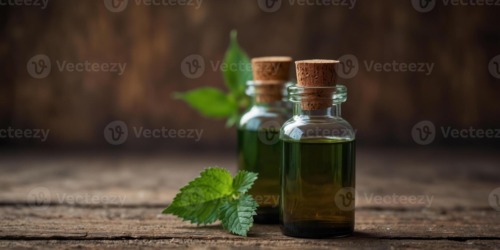 Organic nettle essential oils in glass bottles on rustic wooden background. photo