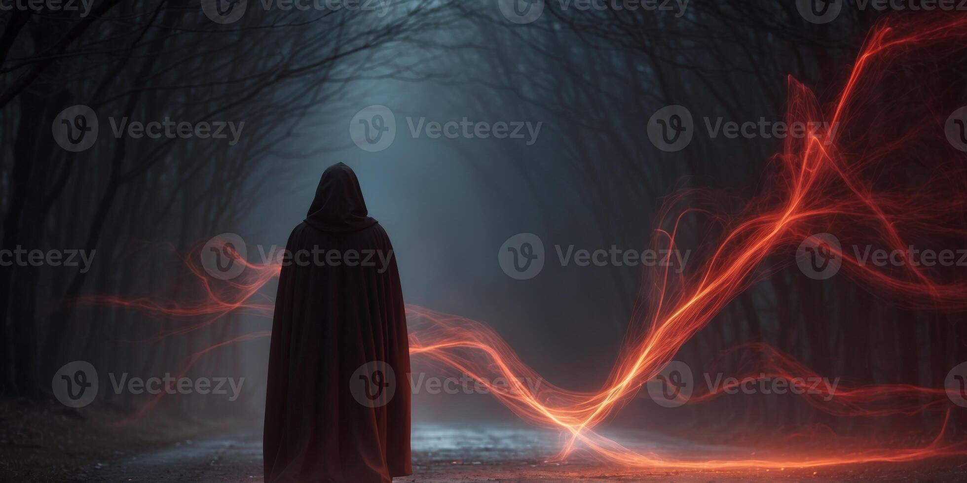 mysterious cloak figure with glowing red energy in dark. photo