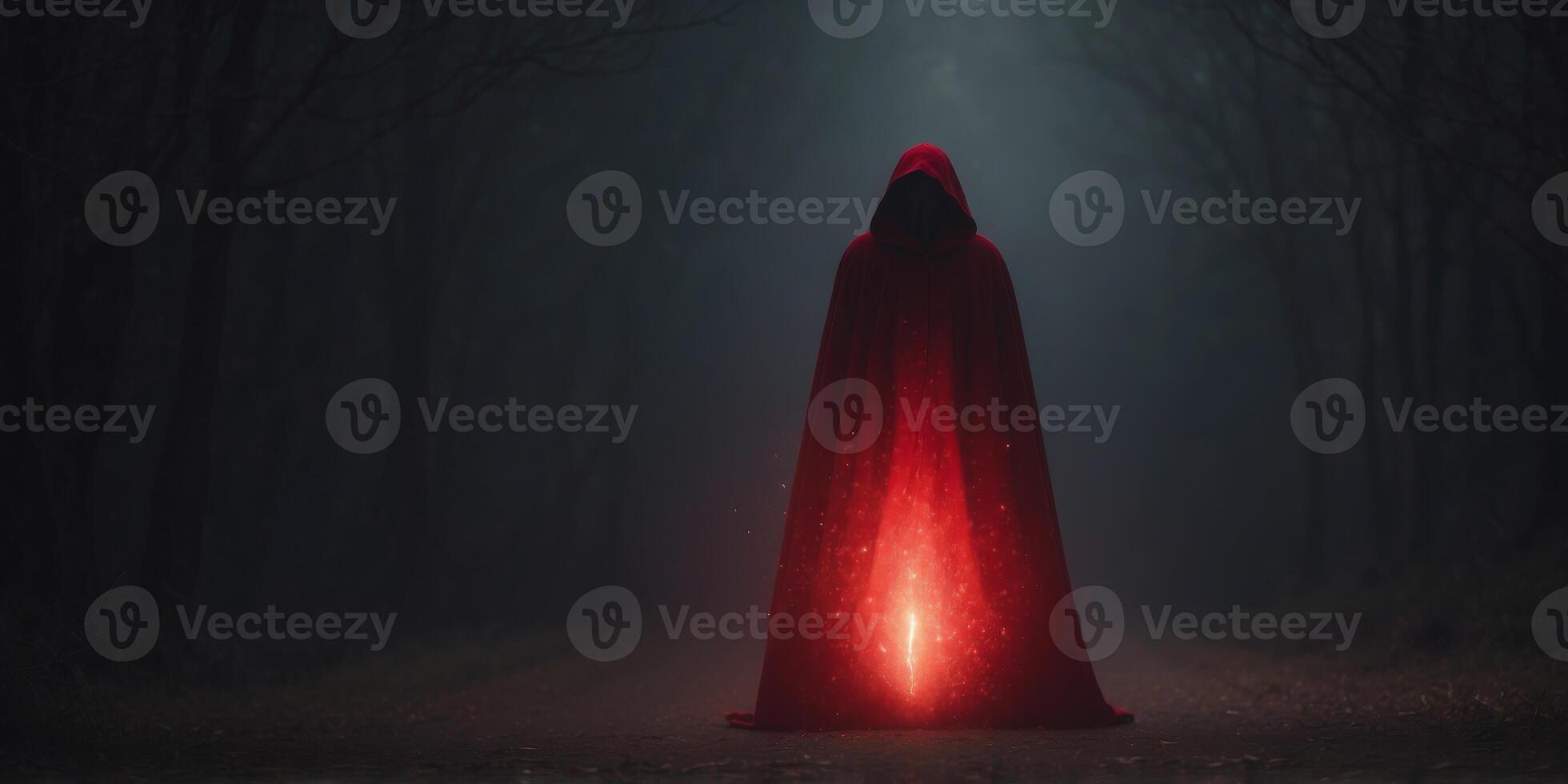 mysterious cloak figure with glowing red energy in dark. photo
