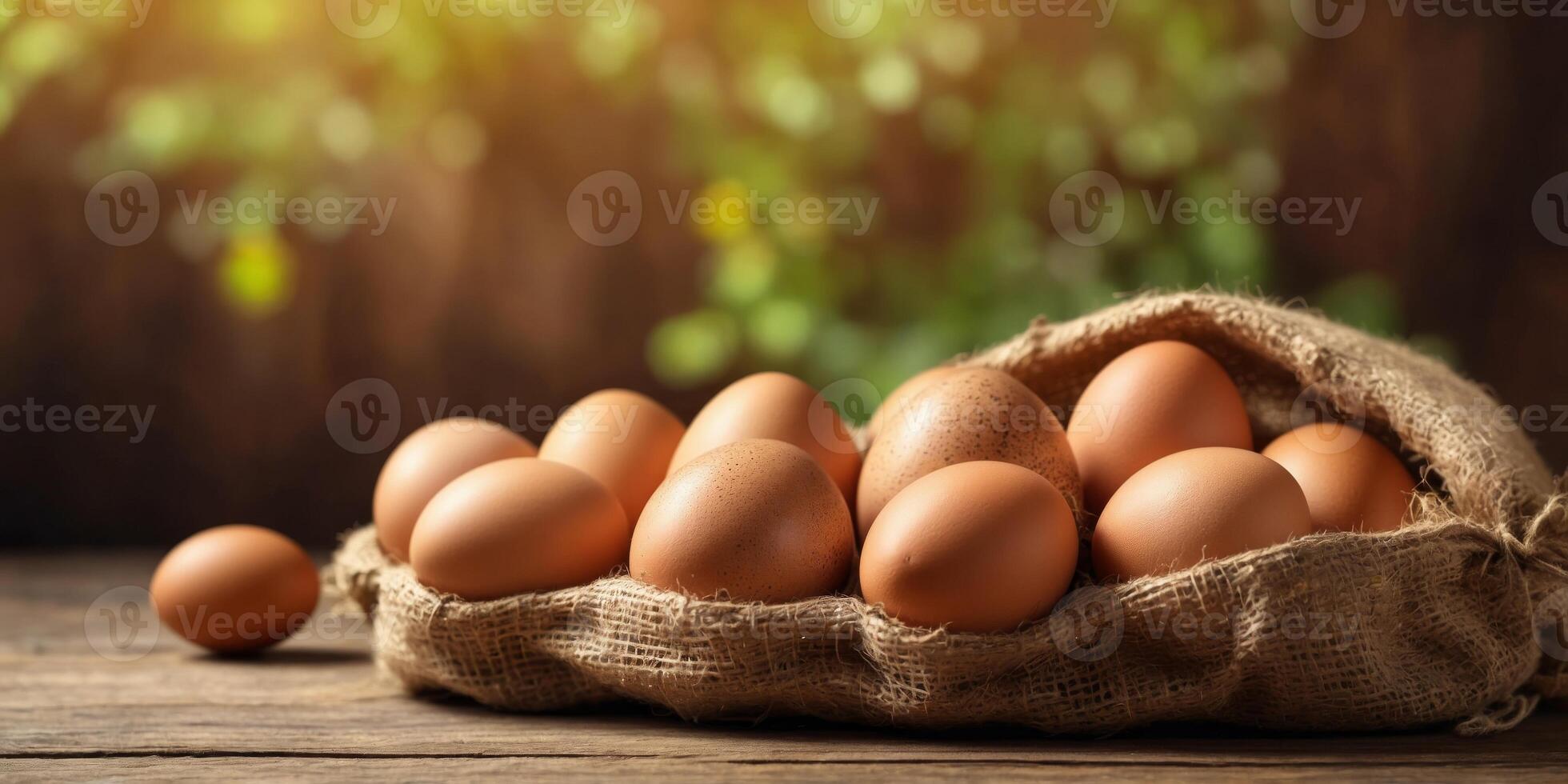Fresh brown eggs in a rustic burlap sack on wooden table. photo