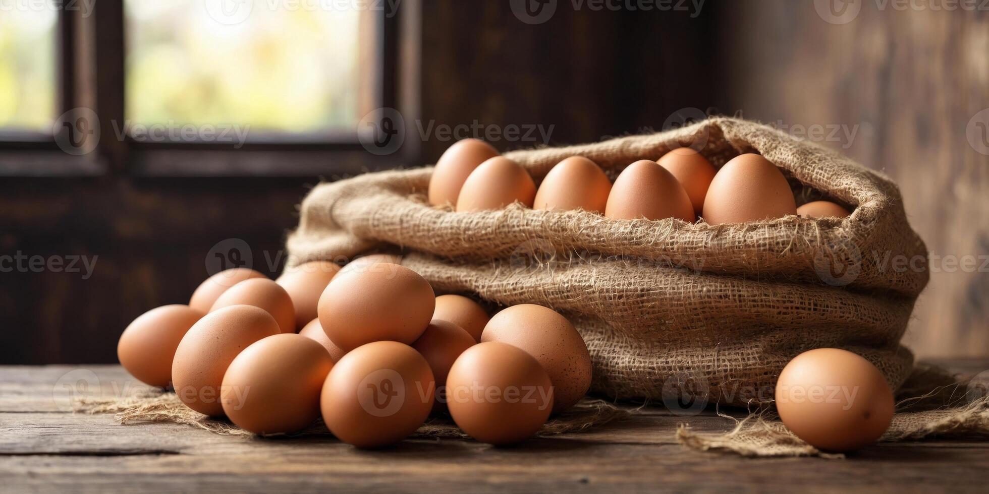 Fresh brown eggs in a rustic burlap sack on wooden table. photo
