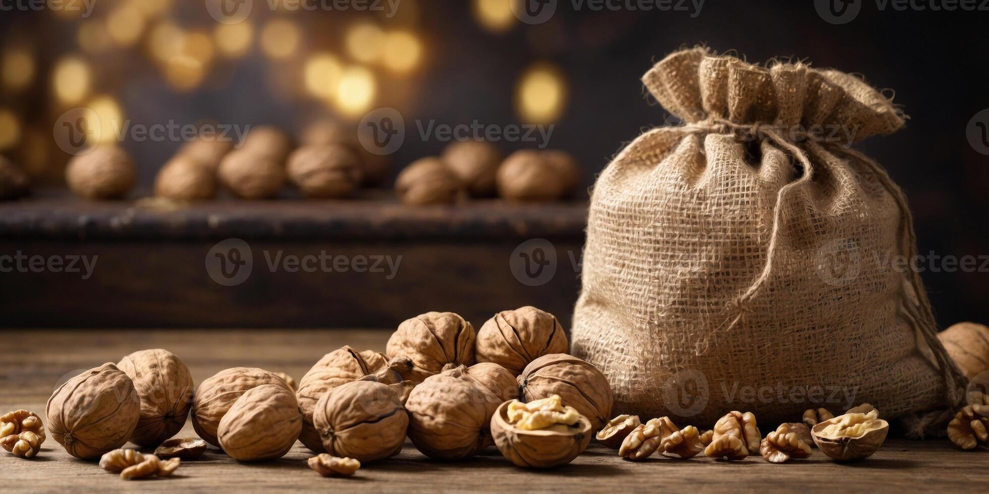 Rustic Burlap Sack Spilling Whole Walnuts on Wooden Table. photo