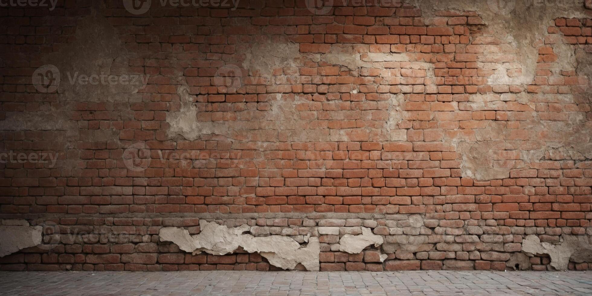 Weathered brick wall with peeling plaster and exposed bricks. photo