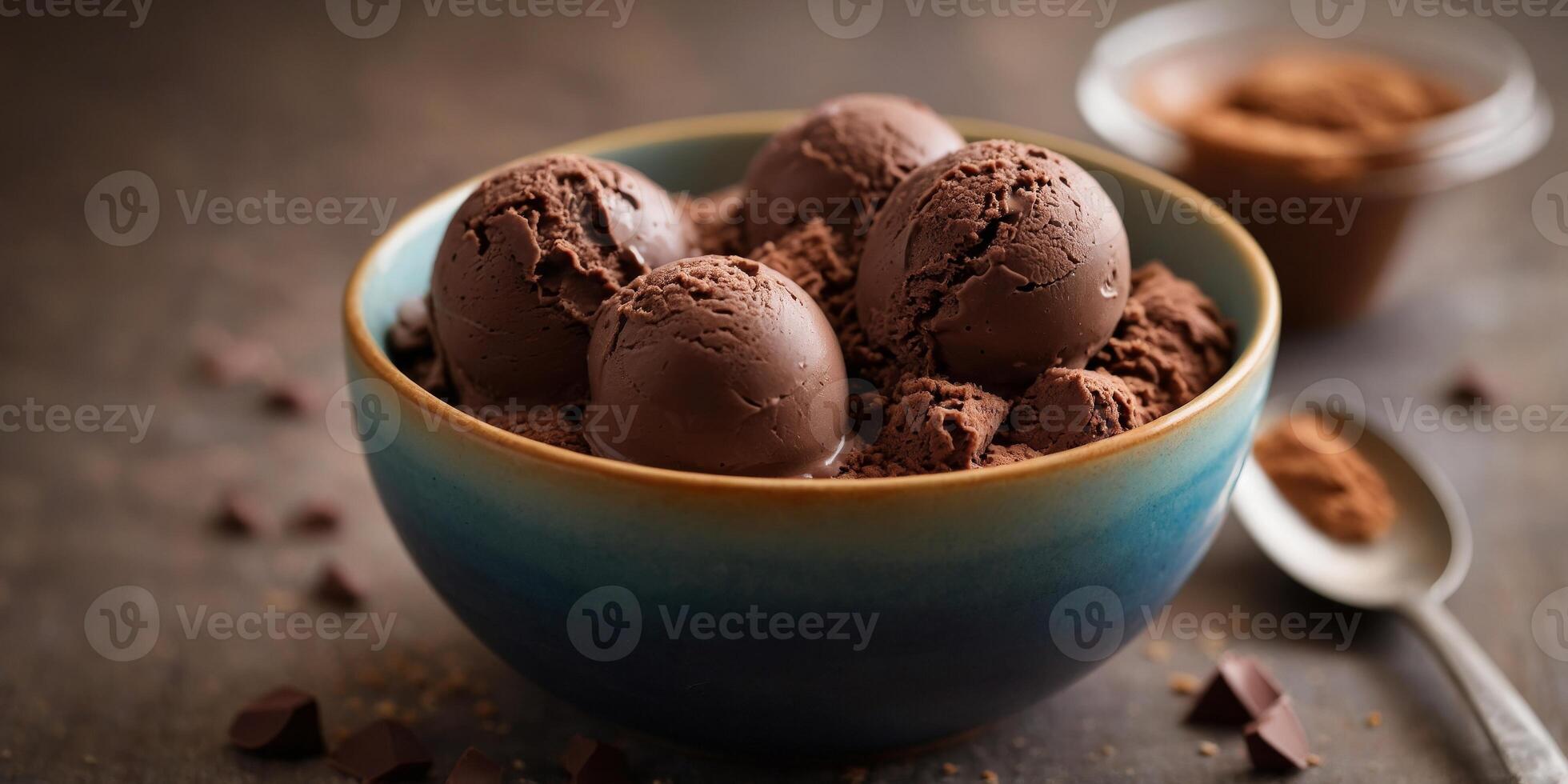 A delicious and rich dessert featuring three scoops of chocolate ice cream served in a bowl. photo