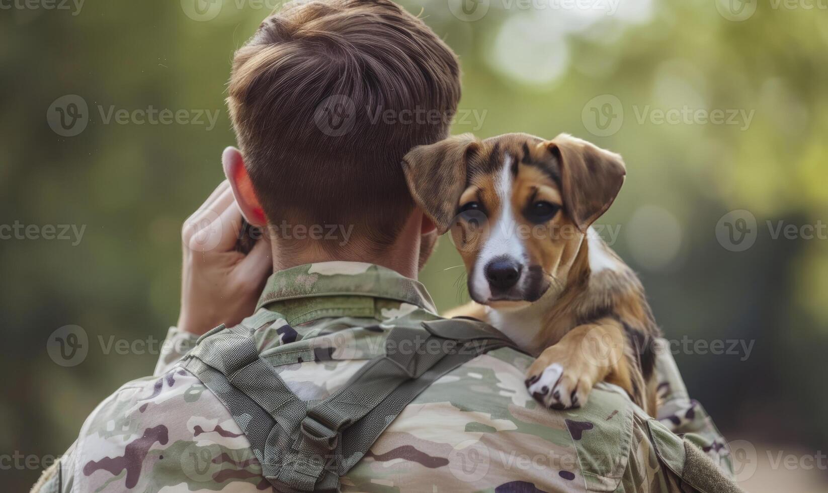 An American soldier holds his dog in shoulder with an american flag and blurred greenery in background photo