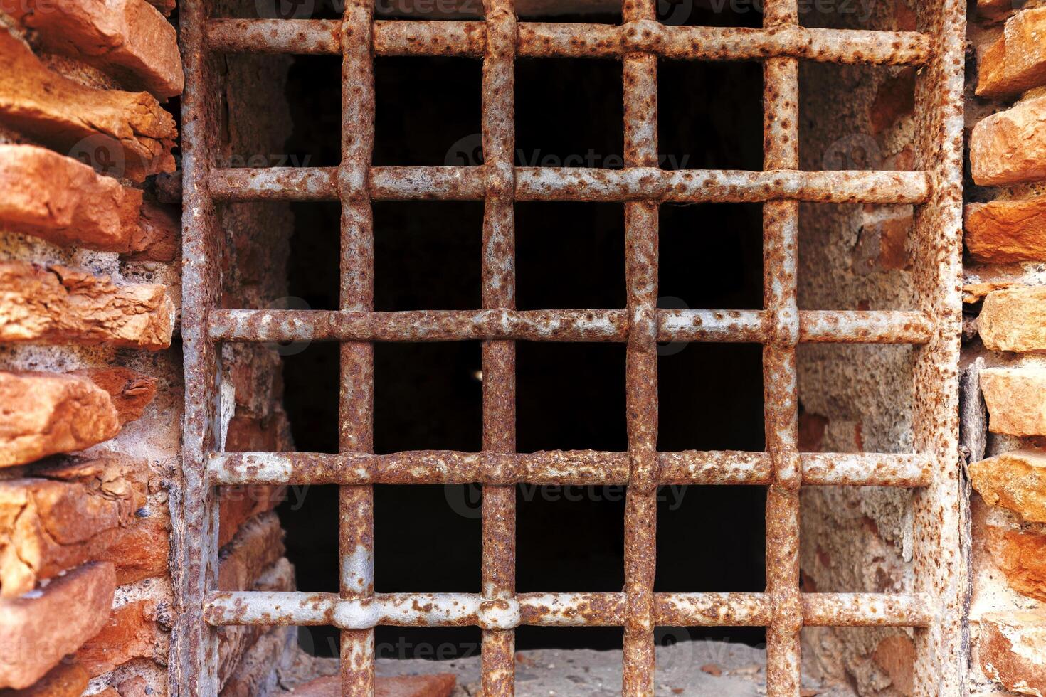 Old rust metal lattice on the prison window photo