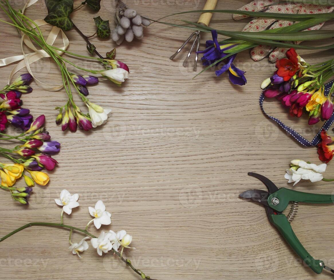 a table with a bunch of flowers and a pair of scissors photo