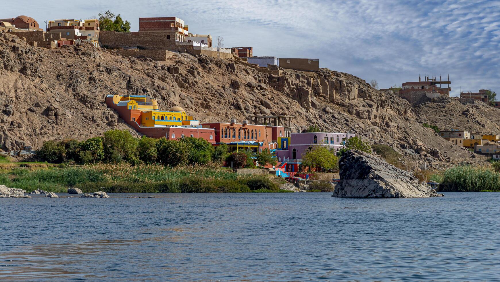Nubian building on the Nile River in Aswan, Egypt photo
