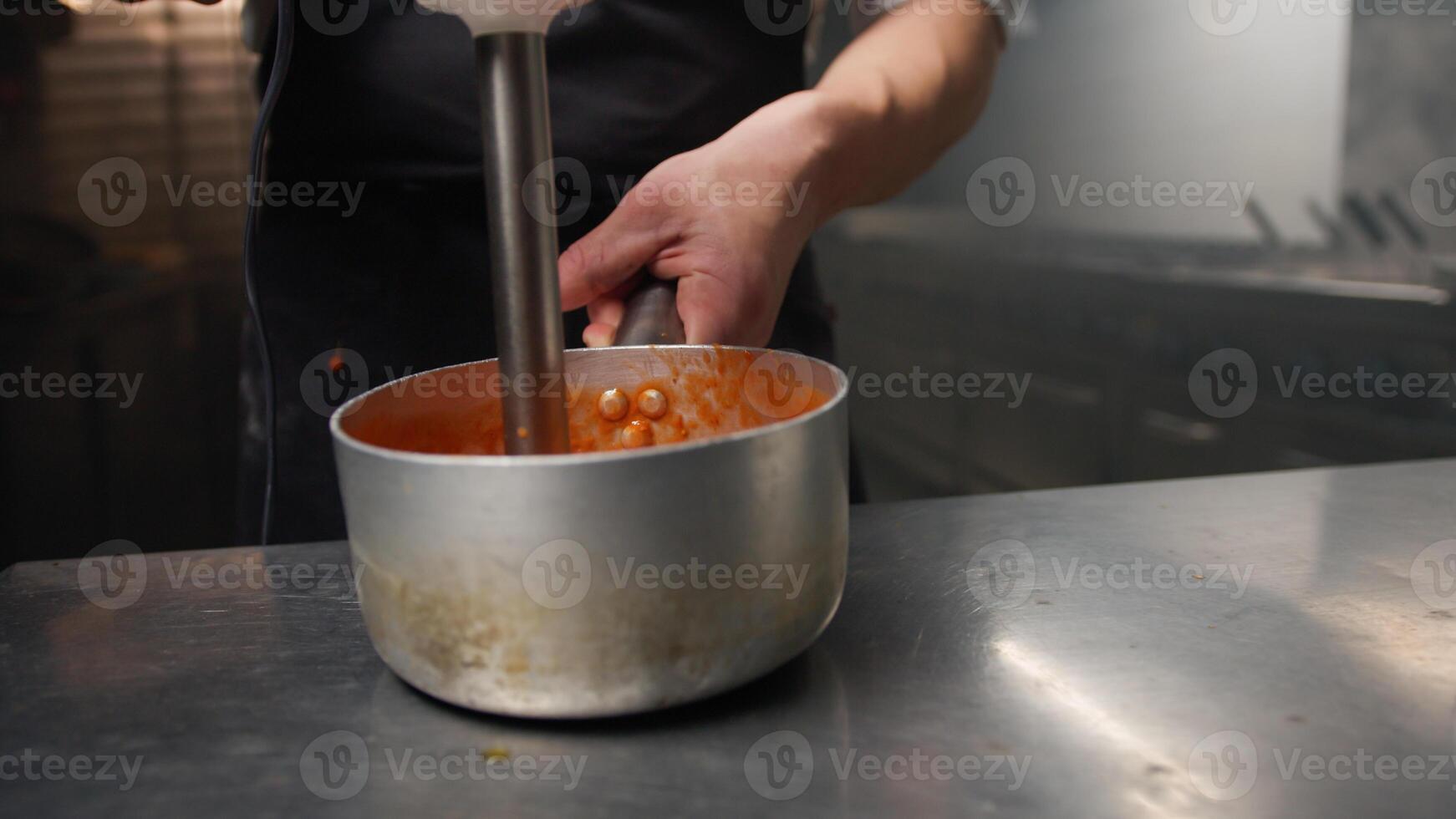 Using Tools In A Kitchen To Create Tomato Cream photo