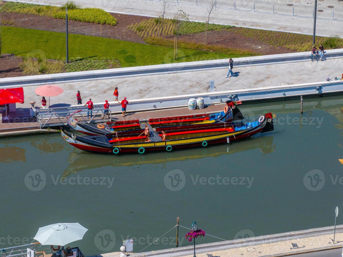 Beautiful aerial view of Aveiro city in Portugal. Aveiro Water canal of Ria de Aveiro with typical boats and tourists, cityscape in the background. photo